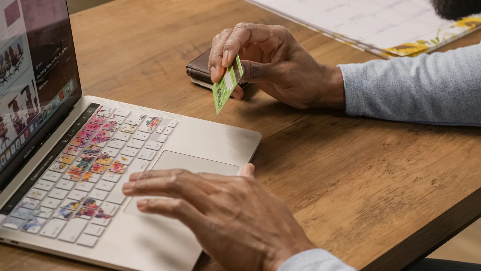 Customer paying online with a card on a laptop